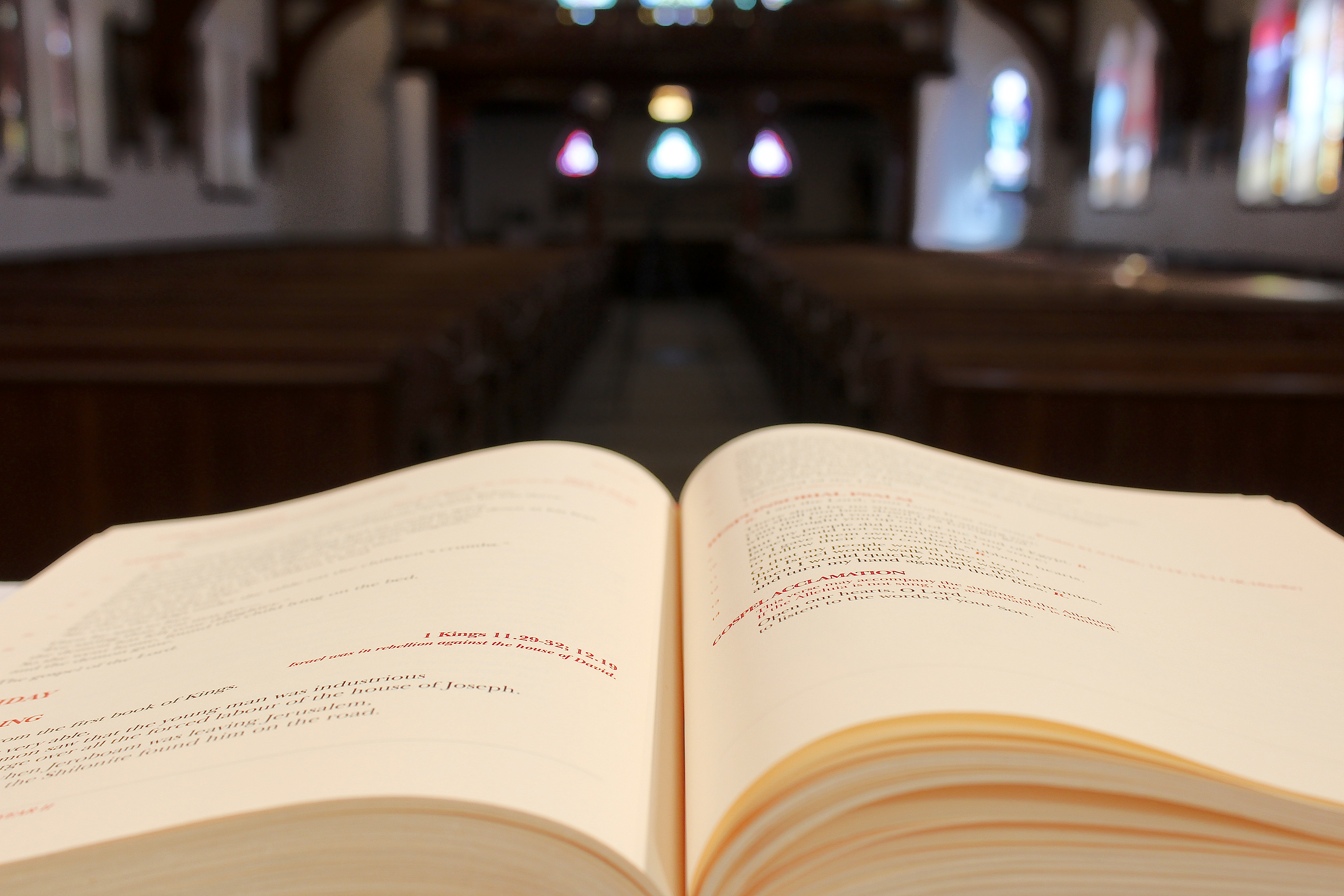 An open lectionary with a view of the church body in the background