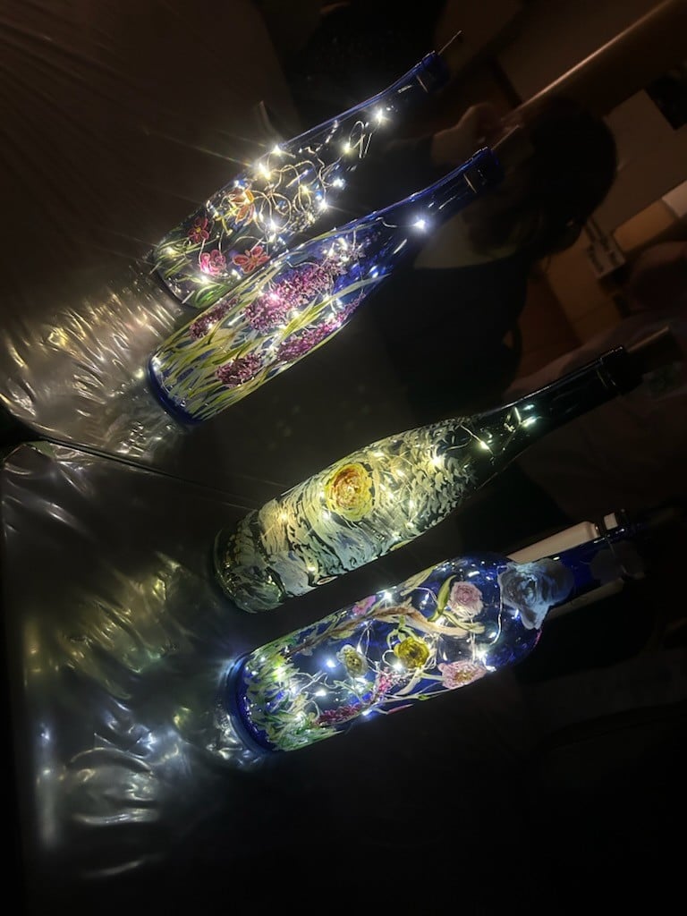Third set of blue painted bottles with lights