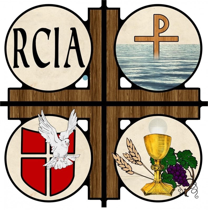 RCIA a wooden cross with circles at each corner. each circle represents the 3 sacraments of RCIA, Baptism, Communion and Confirmation