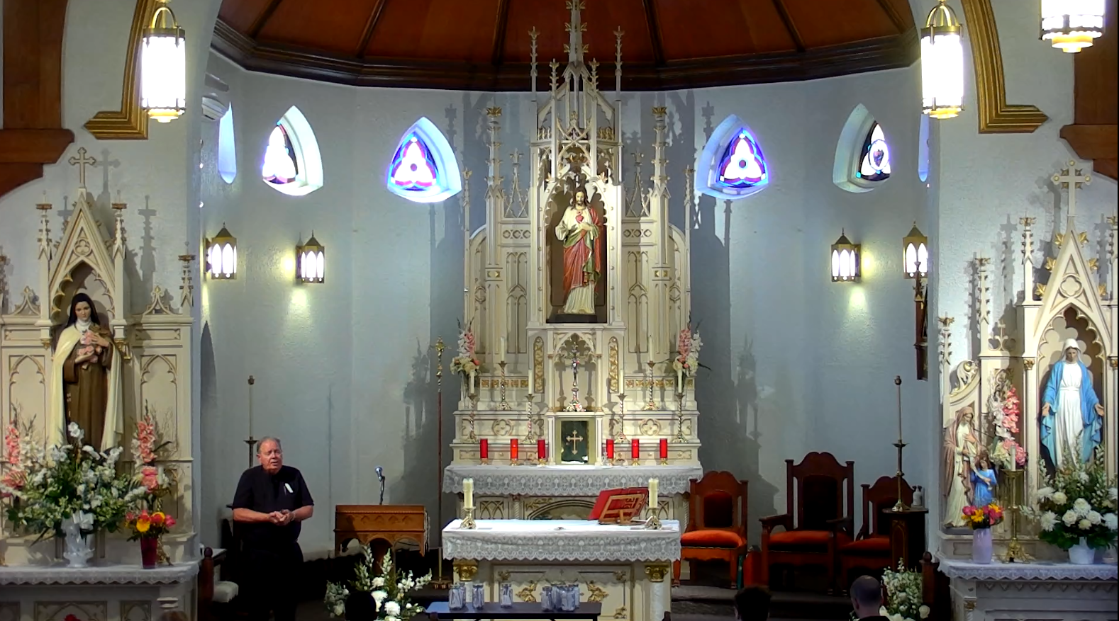 Priest standing in sanctuary of Roman  Catholic church